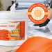 Antibacterial wipe bucket in white with orange branding, protruding sheet, and 1000-sheet label; Liquidate® Sunbed & Salon wipes.