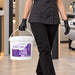 Antibacterial wipes in a white plastic bucket with purple label and handle, carried by a gloved salon worker; Liquidate® Sunbed & Salon, 500 sheets.