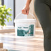 Antibacterial wipe bucket in white plastic with teal yoga-themed label and carry handle, Liquidate® Yoga & Pilates, 600 sheets.